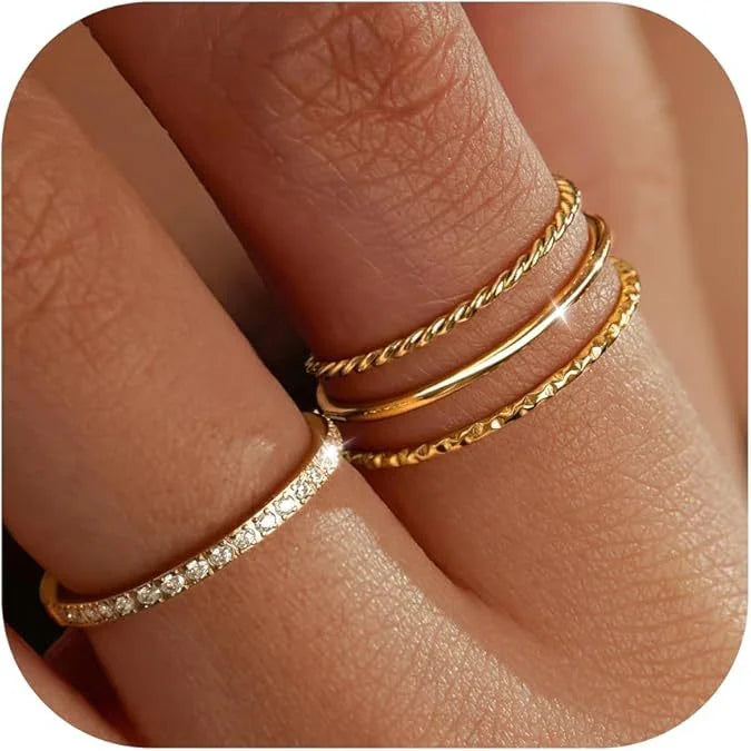 Gold stacking rings and diamond band on fingers, Moment Jewels minimalist jewelry