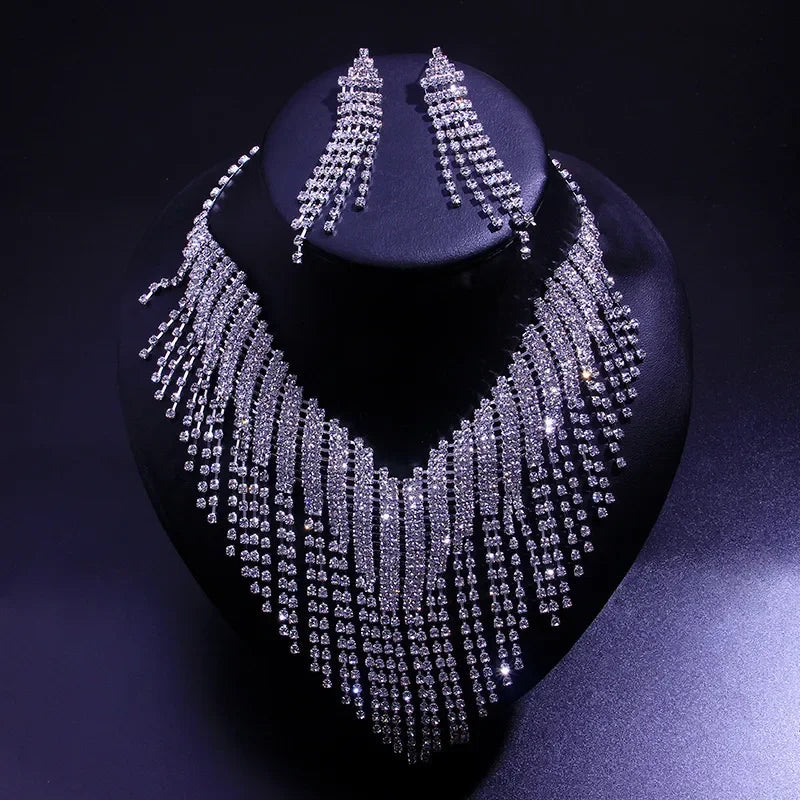 Rhinestone fringe necklace and earring set on black display, Moment Jewels collection